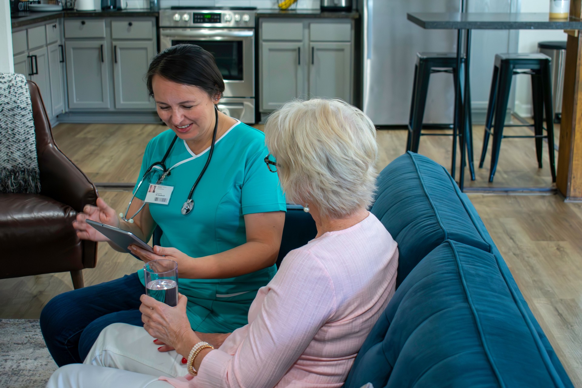 female home health nurse works with elderly patient