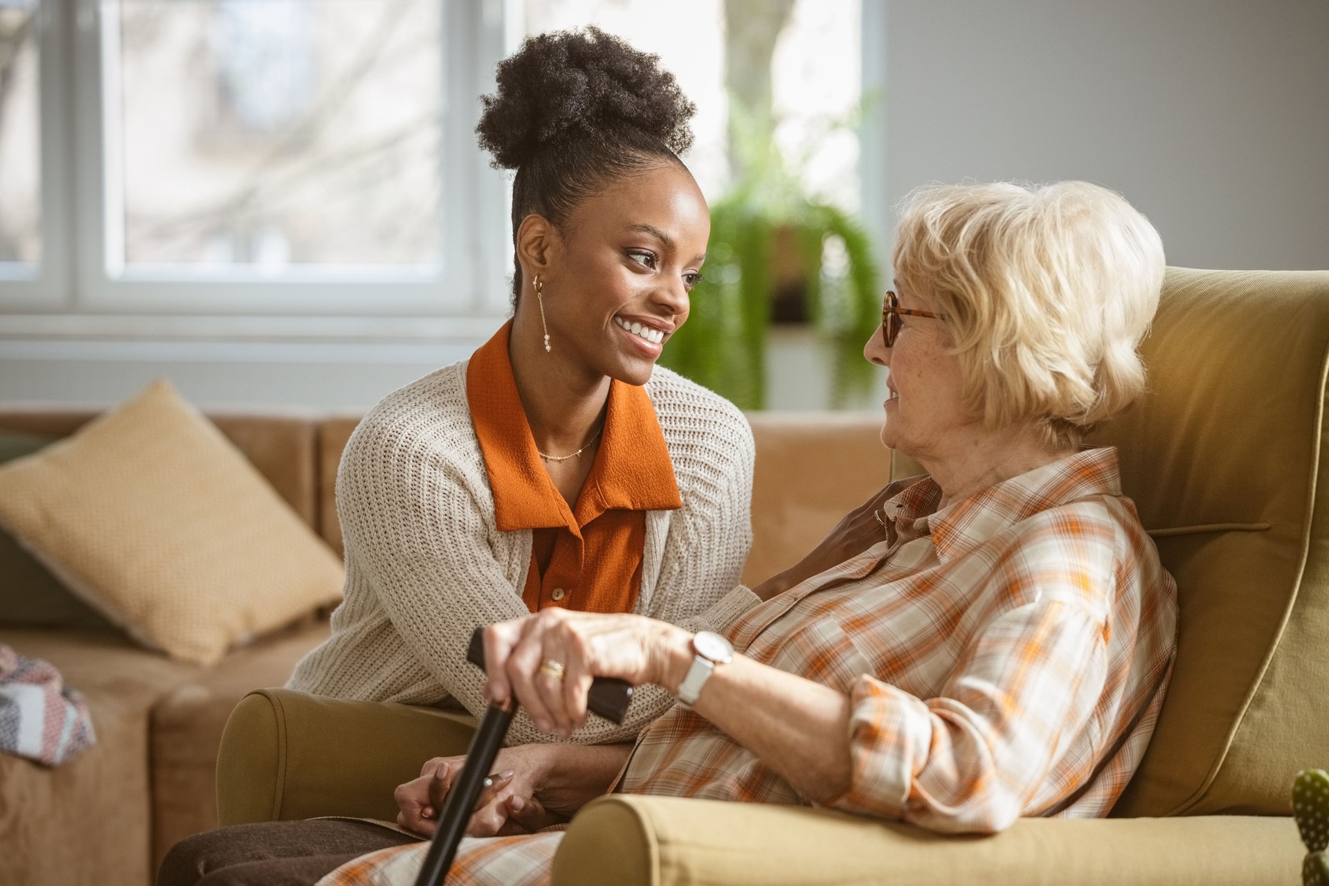 Home caregiver taking care of senior woman